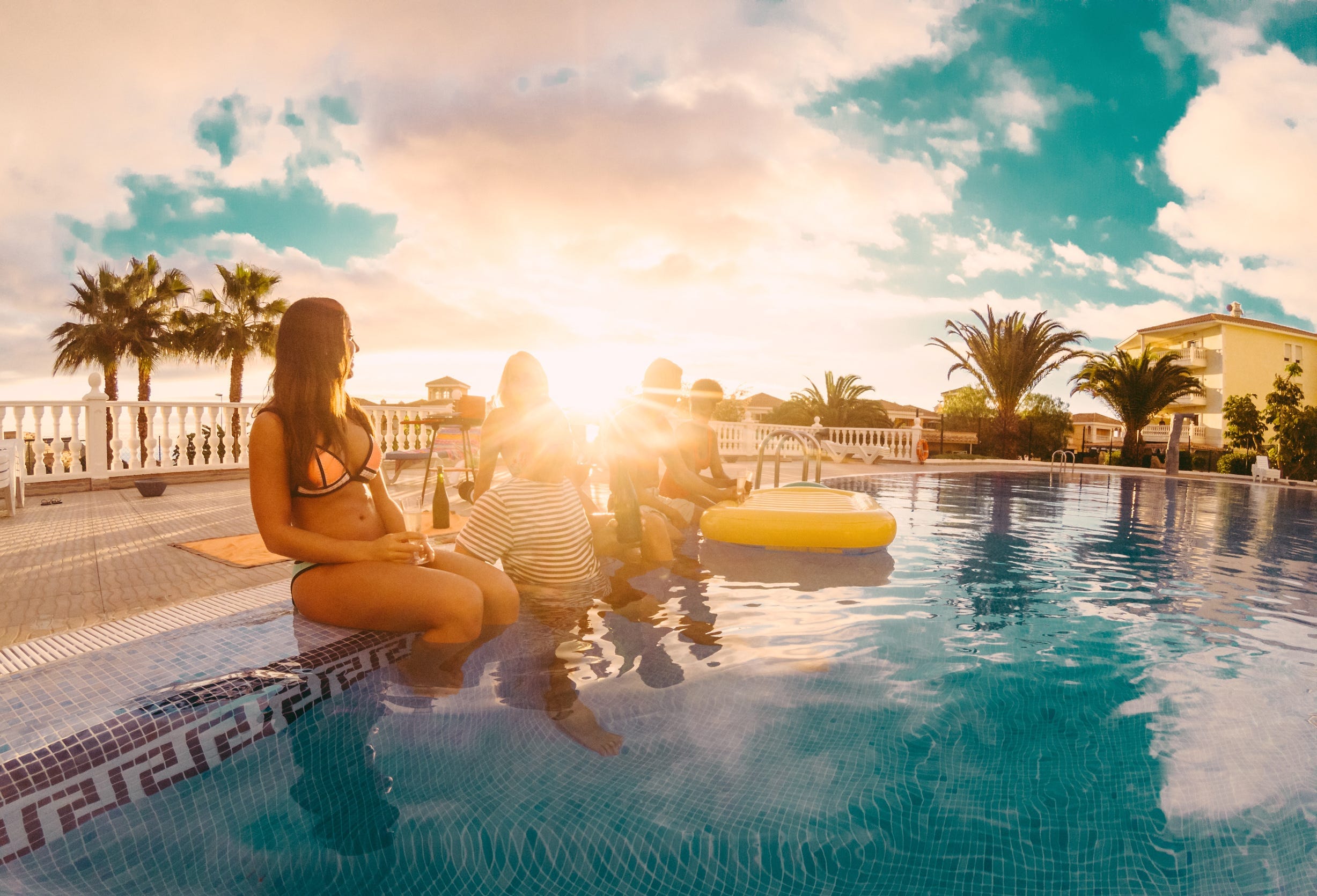Adults hanging out around the pool.jpeg