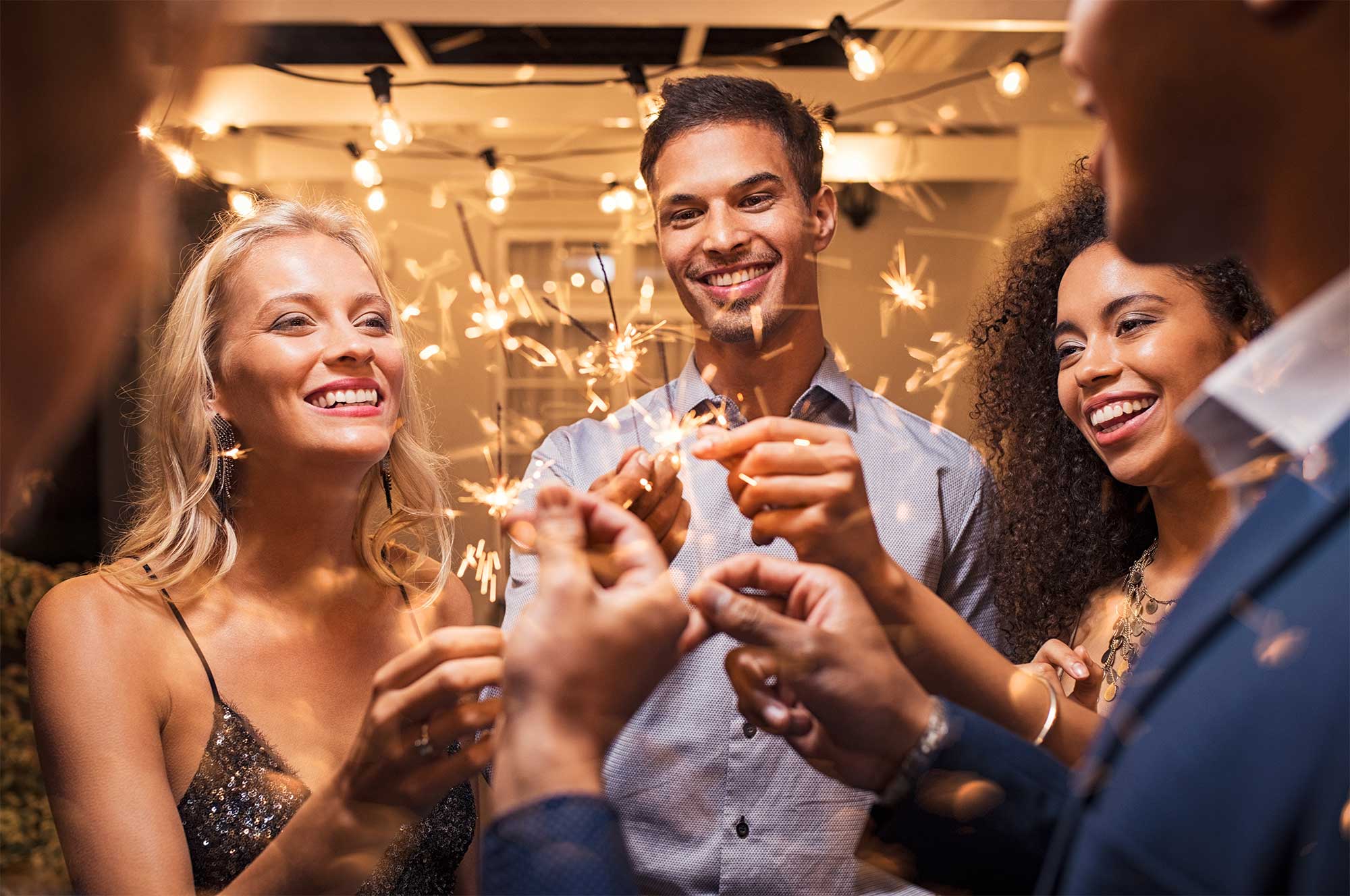 Group_celebrating_New_Year’s_with_sparklers.jpg
