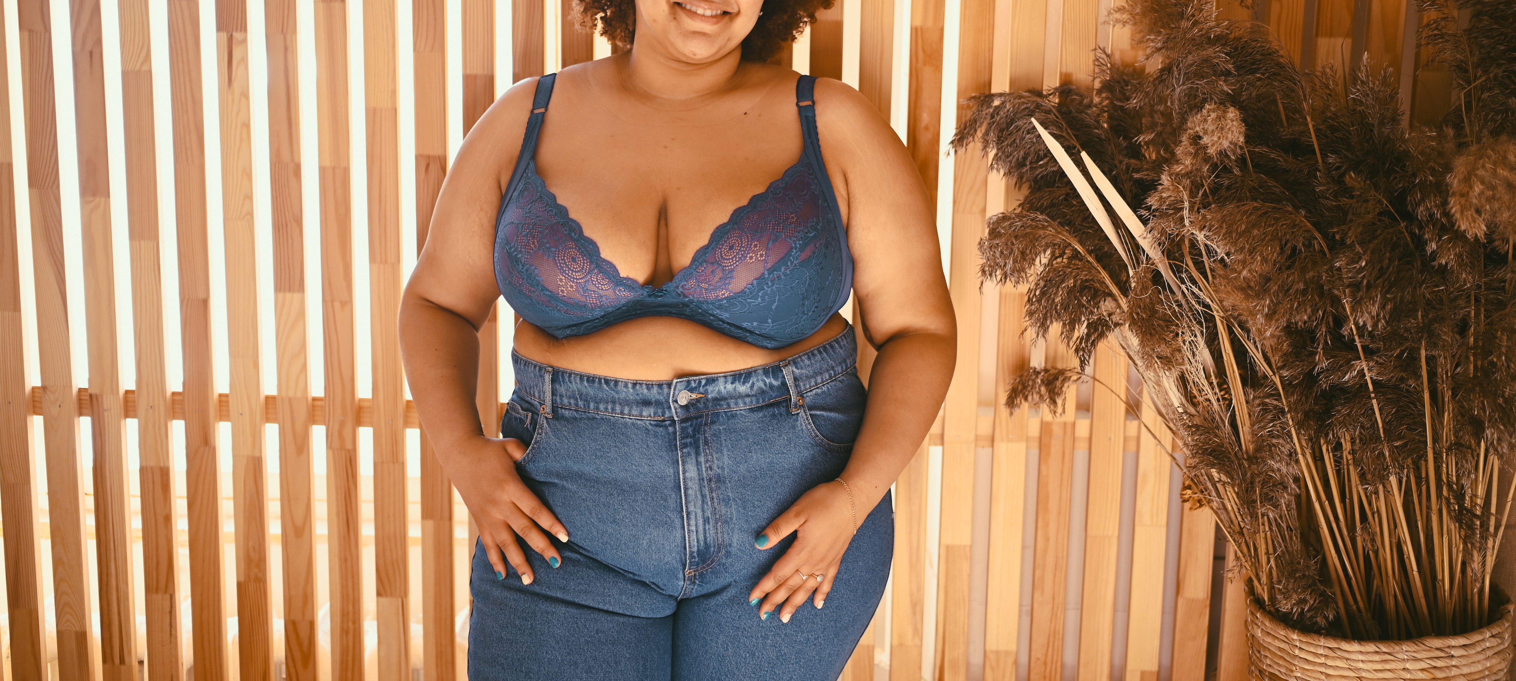 Black plus size woman wearing a blue lacy bra..jpeg