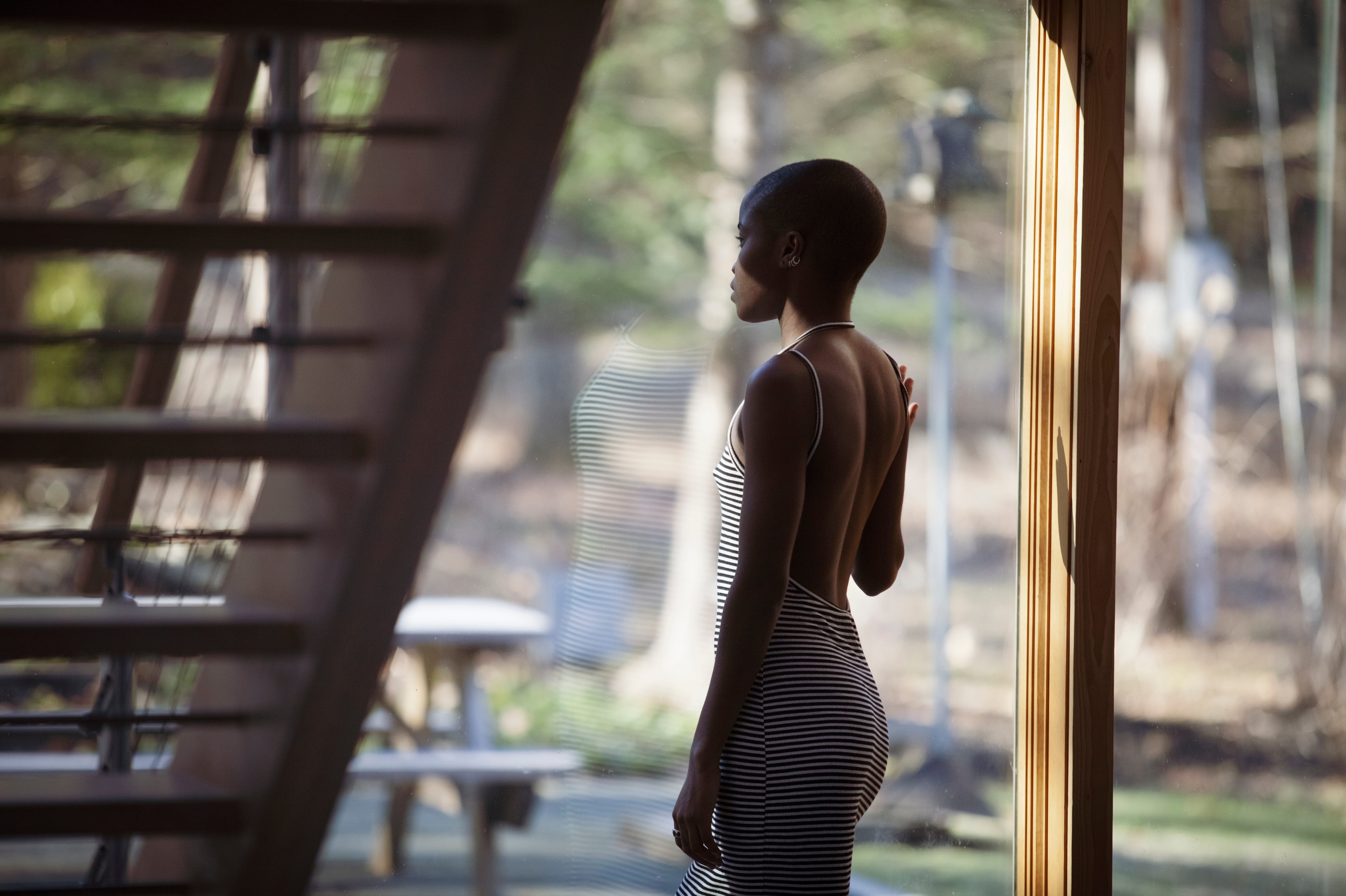 Woman wearing a backless dress gazing out the window..jpeg