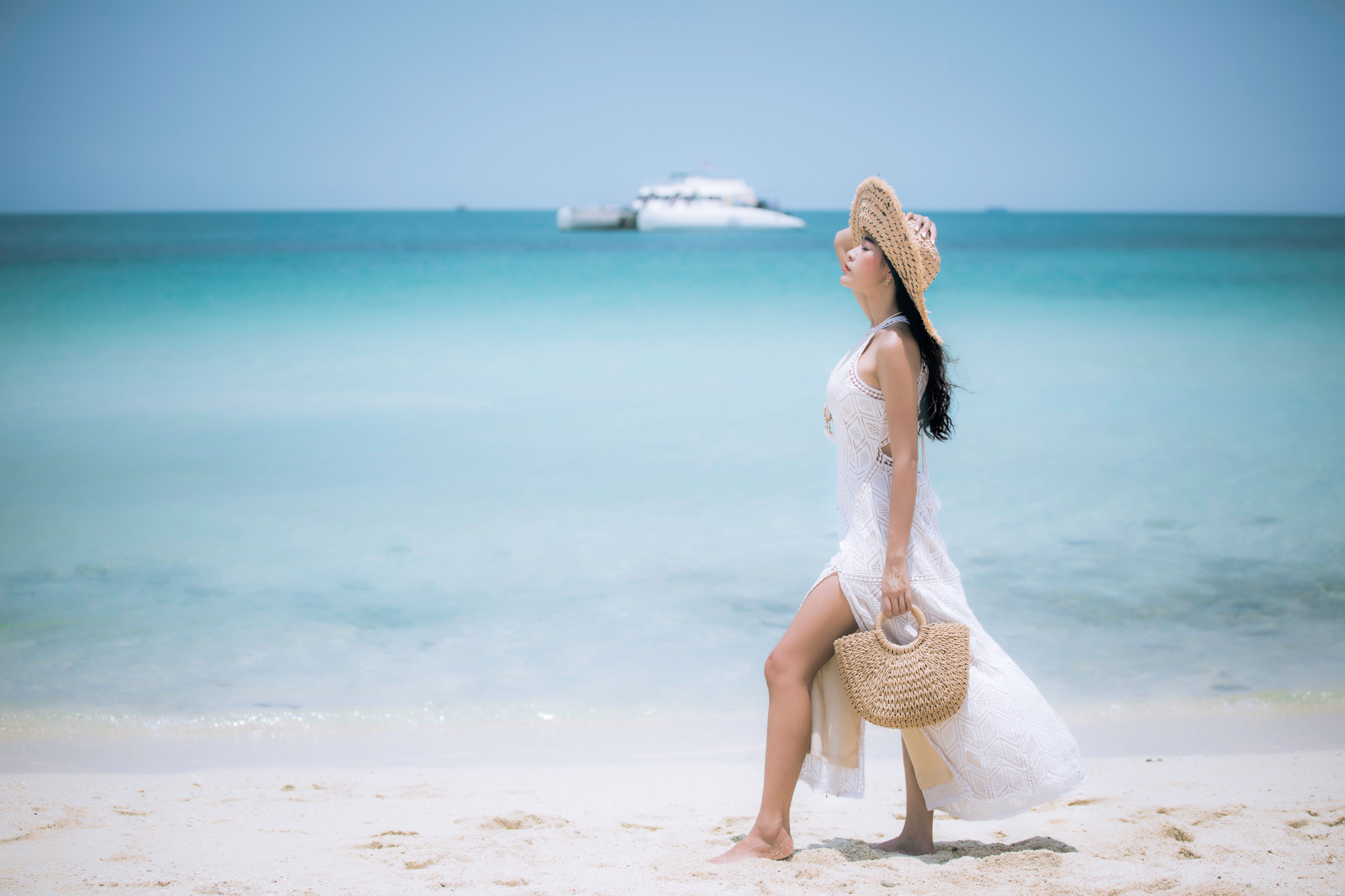Woman walking on the beach in a cover-up dress.jpeg