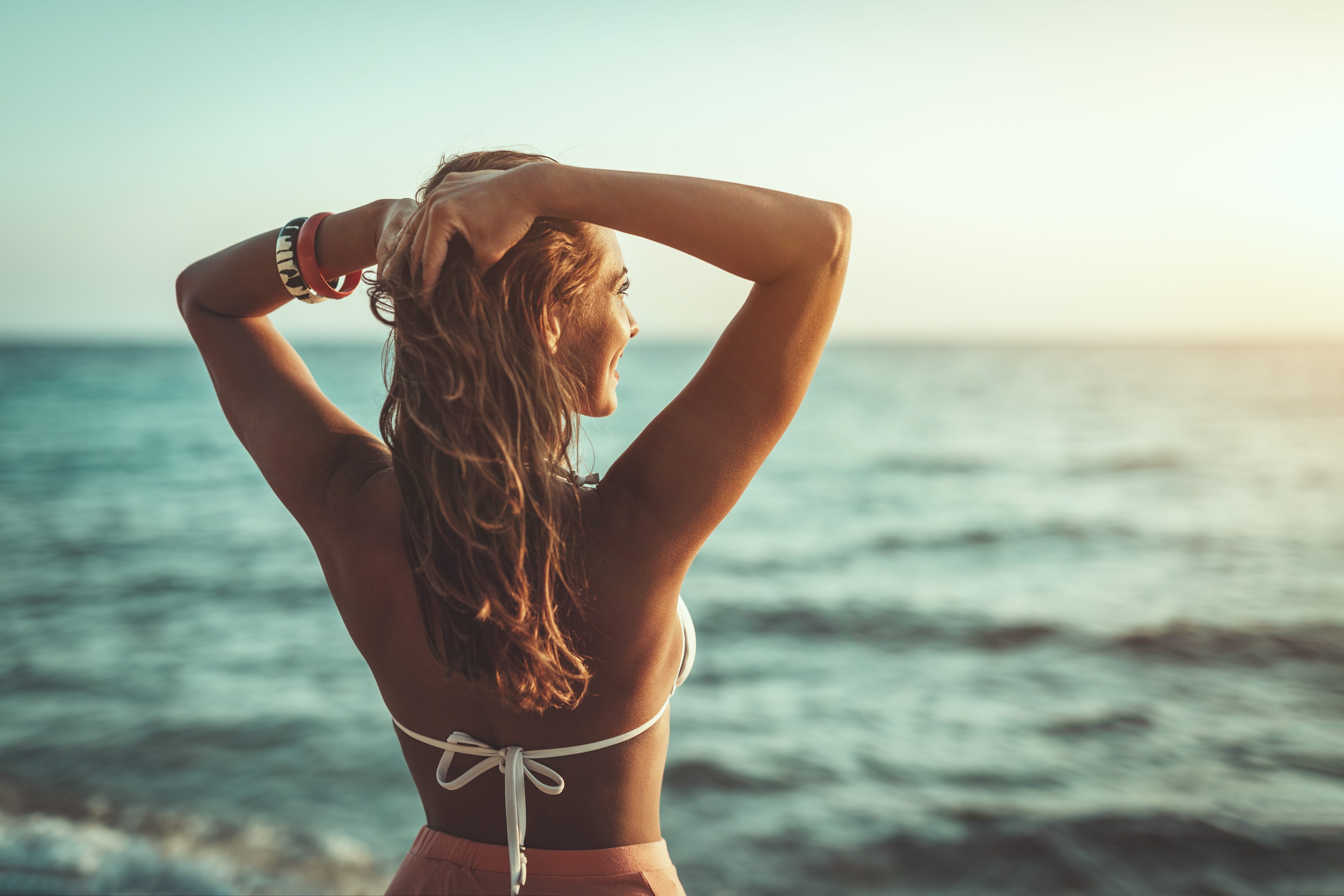 Woman in a swimsuit looking at the ocean.jpeg